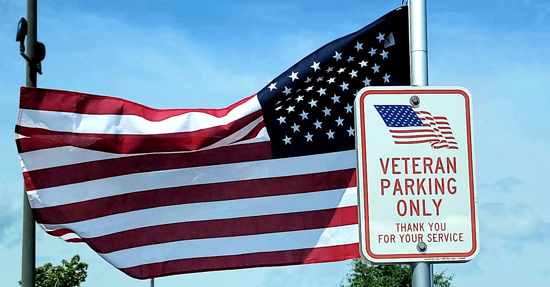 Veteran parking sign and american flag